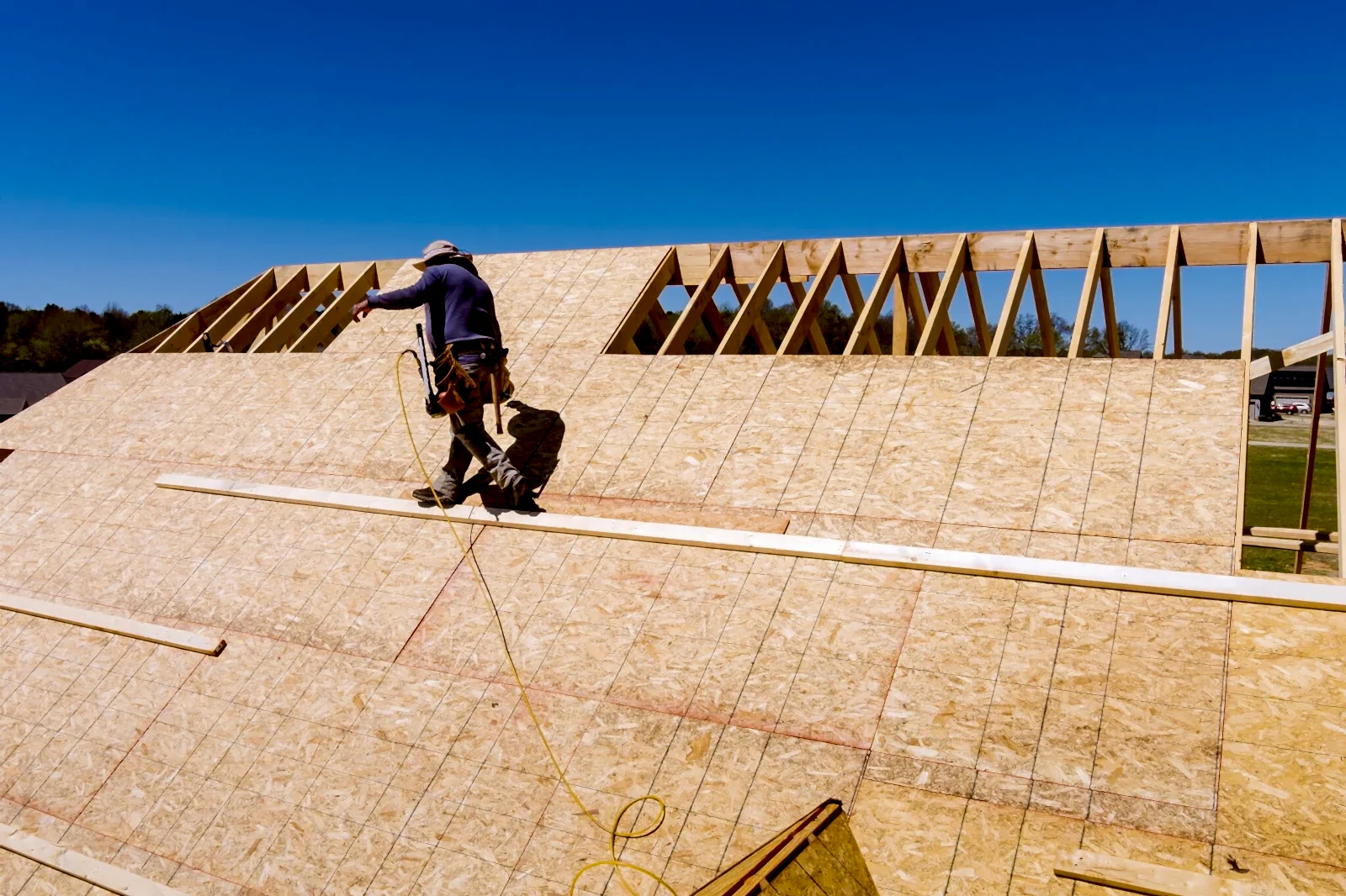 Aerial top view of home roof construction applying roof plywood panels in new house